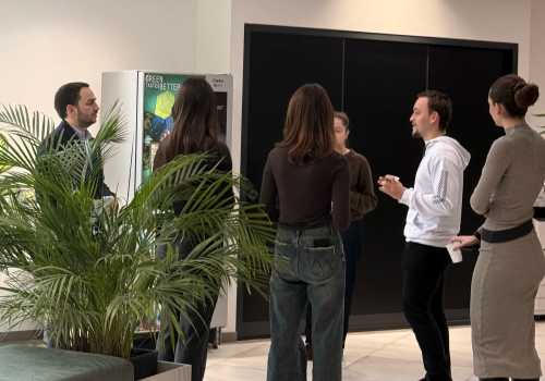 Students listening to Radix's CEO during company visit